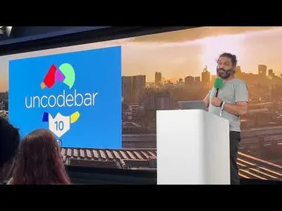 At Google London HQ, 2023 Louie Christie standing at a microphone and lectern. A screen behind him says 'Uncodebar 10'