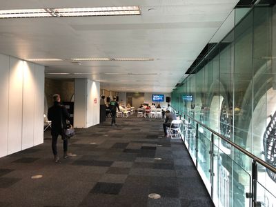 Mostly empty room, mostly empty chairs and stage at the front