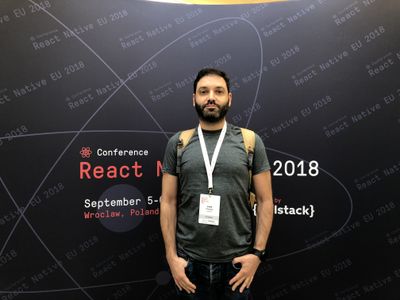 Louie standing in front of a sign for React Native Conference 2018